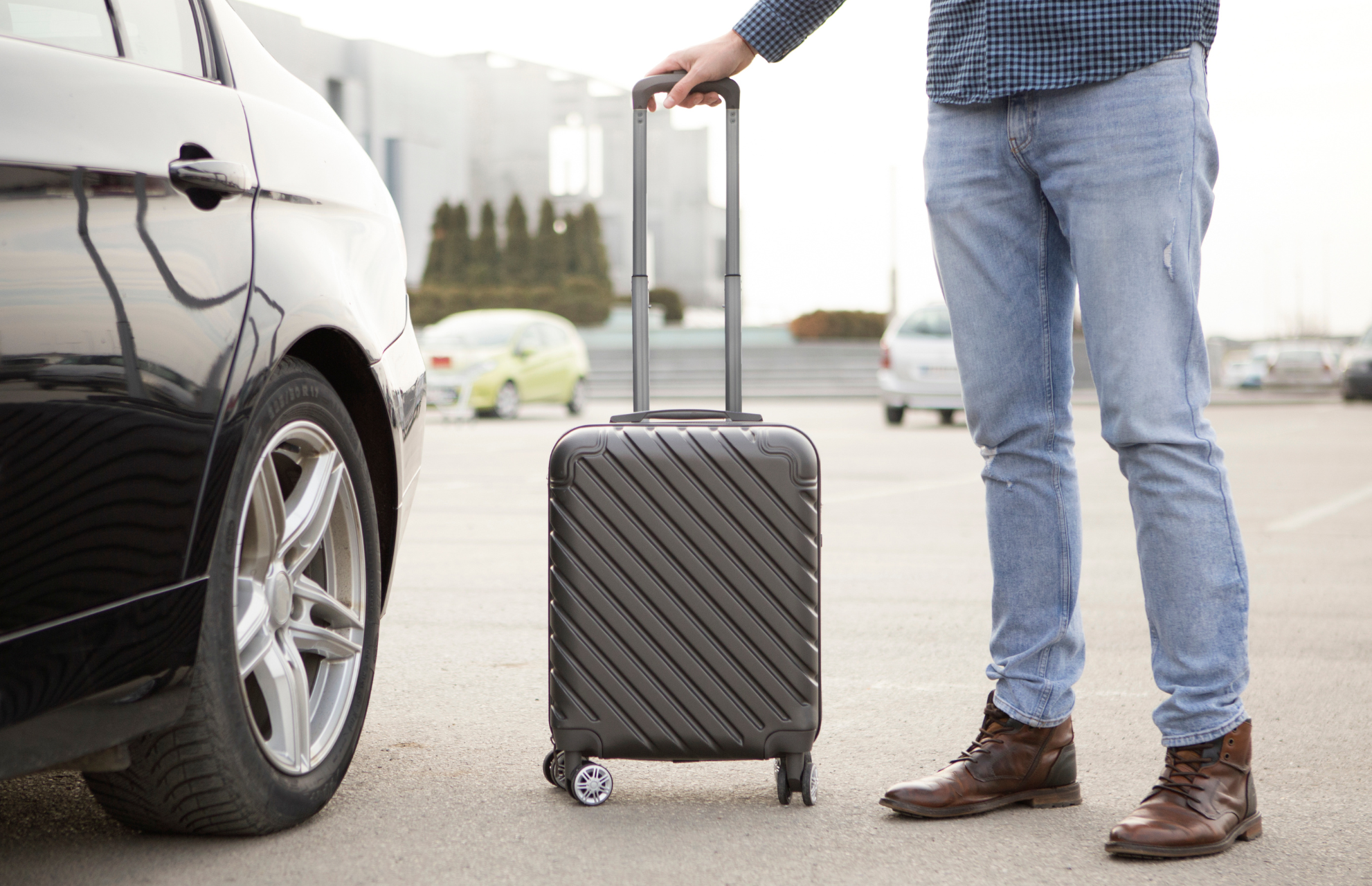 Traveler with suitcase and rental car - Go Rent Car Marrakech contact