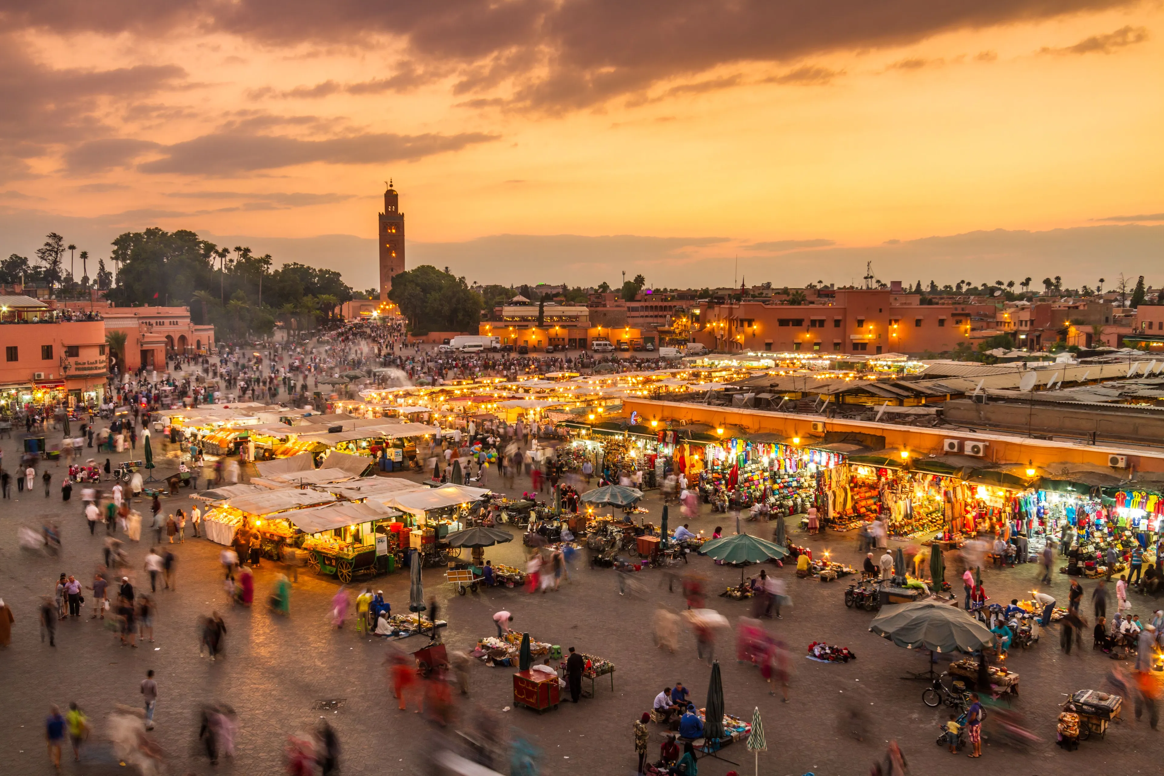 Jemaa el-Fnaa square in Marrakech at sunset with Koutoubia Mosque